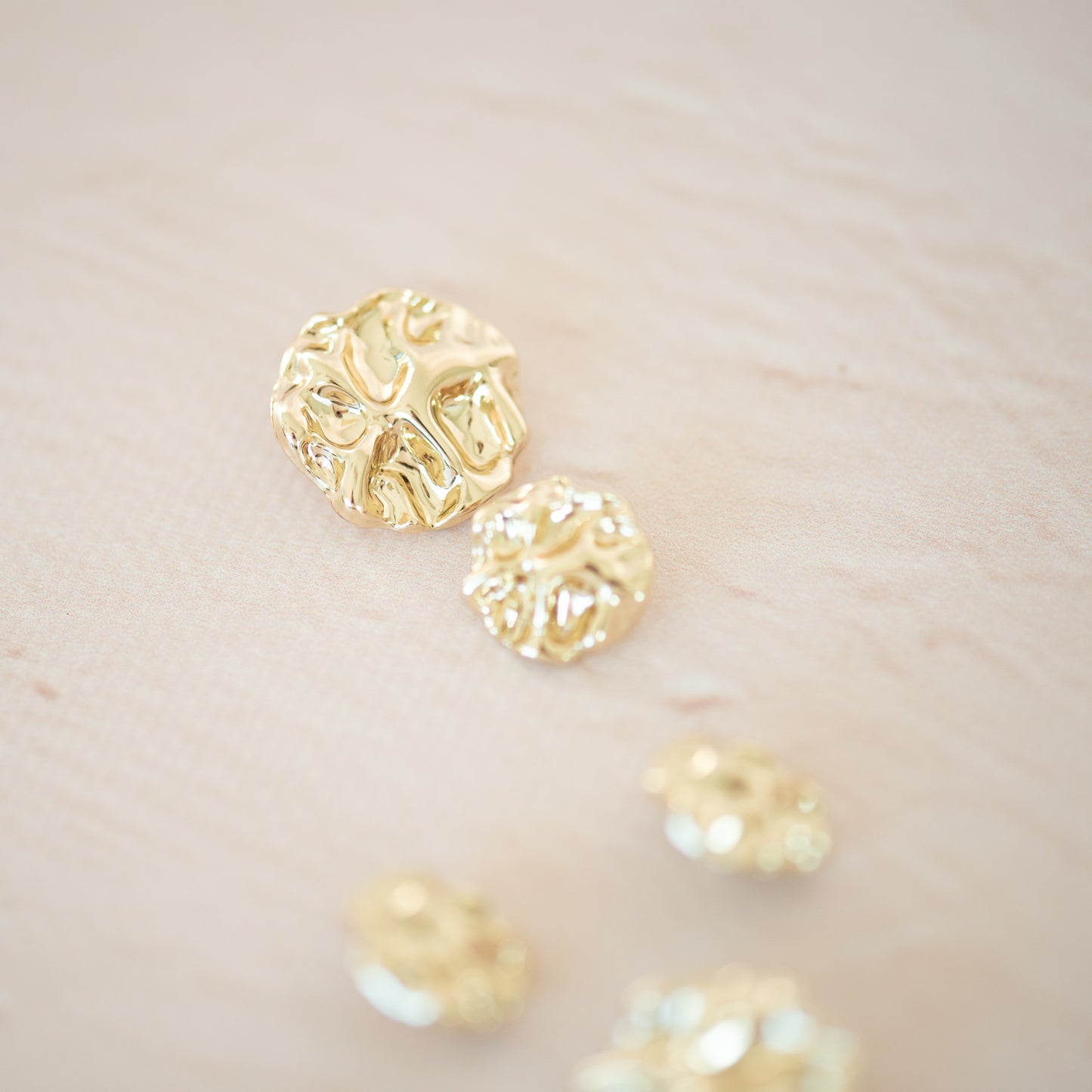Gold asymetric metal button