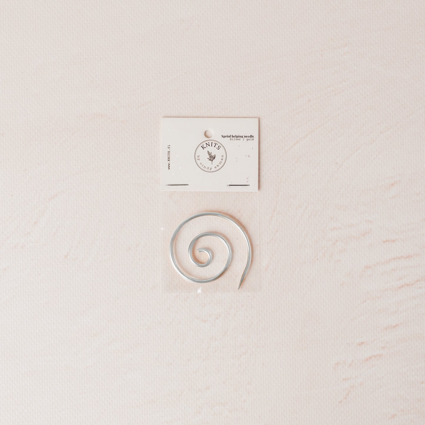 Silver spiral needle for knitting.