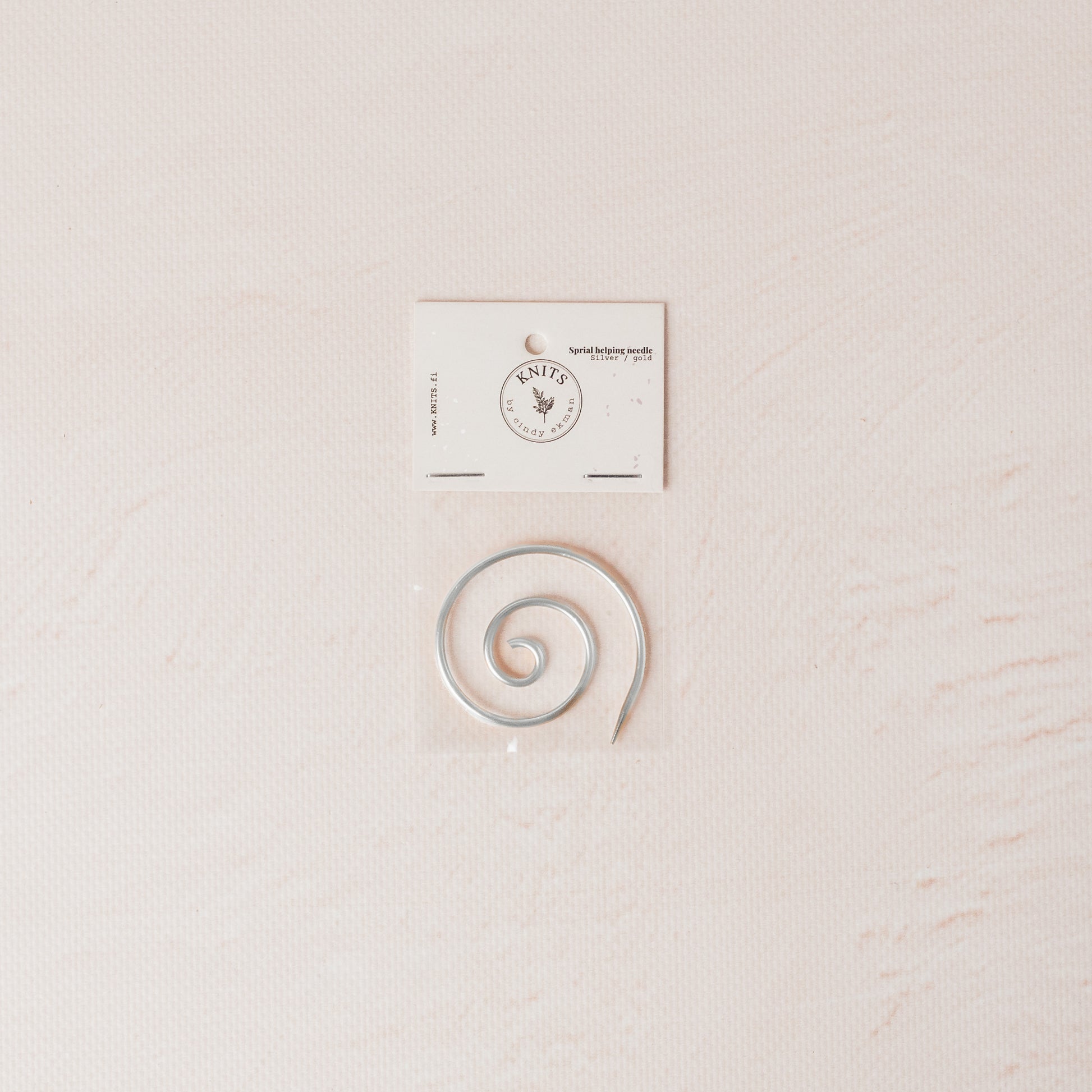 Silver spiral needle for knitting.