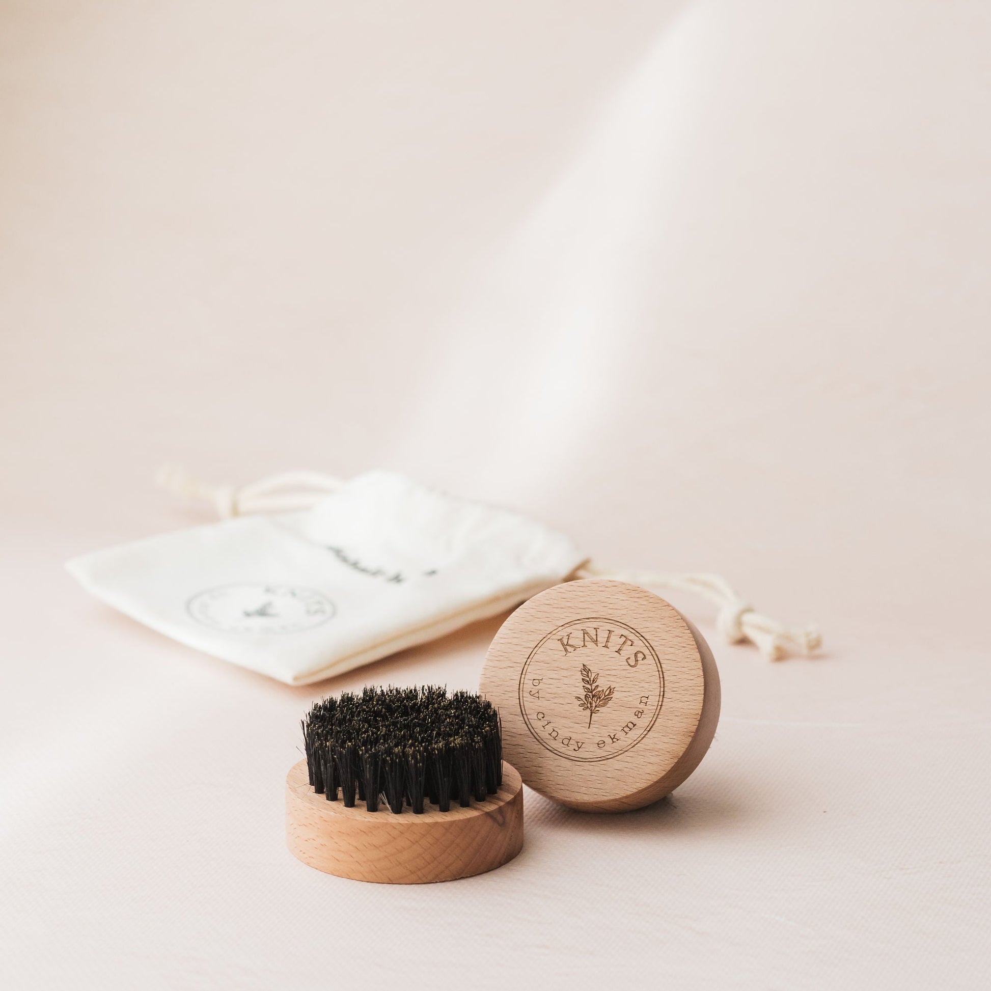 Wooden brush and soap on a light background