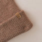 Brown knitted fabric with a brand label on a white background