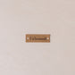 Tålamod label on a textured beige background