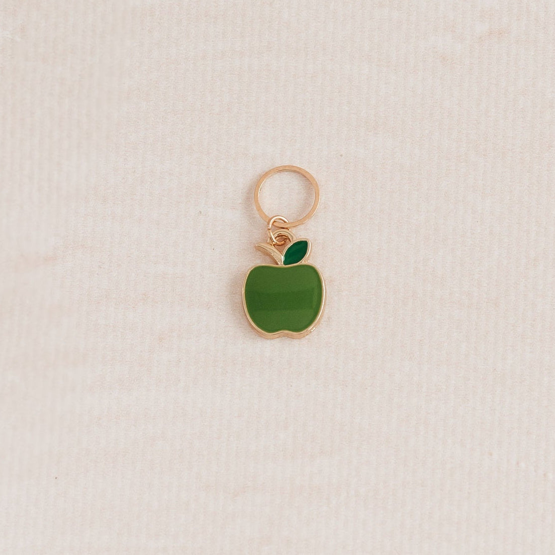 apple charm with ring, used in knitting.